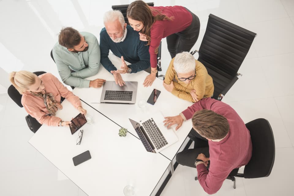Overhead view of a team reviewing performance data together