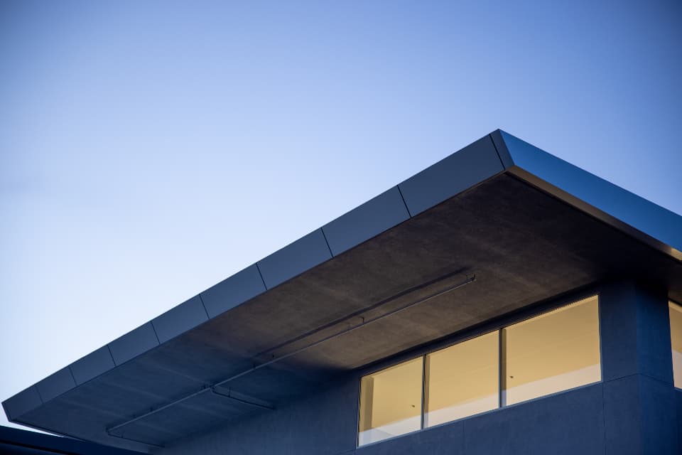 A modern building exterior against a clear evening sky
