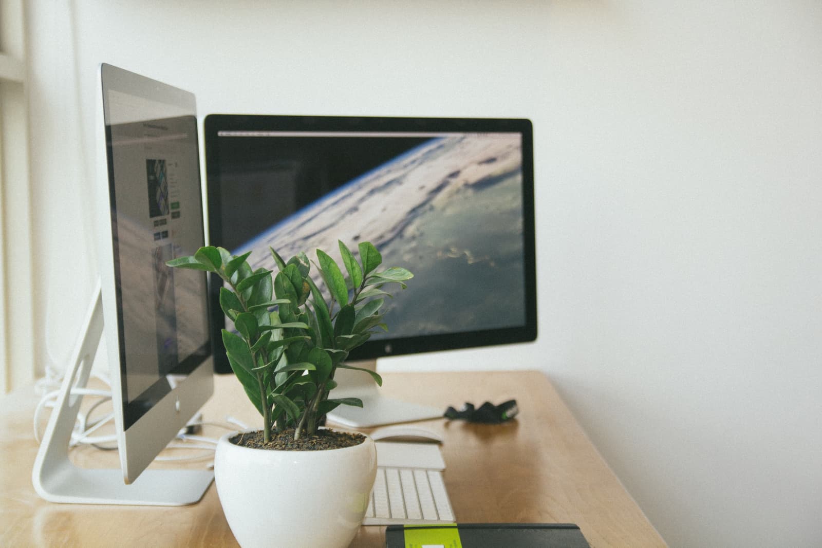 A twin-monitor delivery desk in a bright office